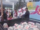 Cesar giving out food bags at the Jenny Smith School